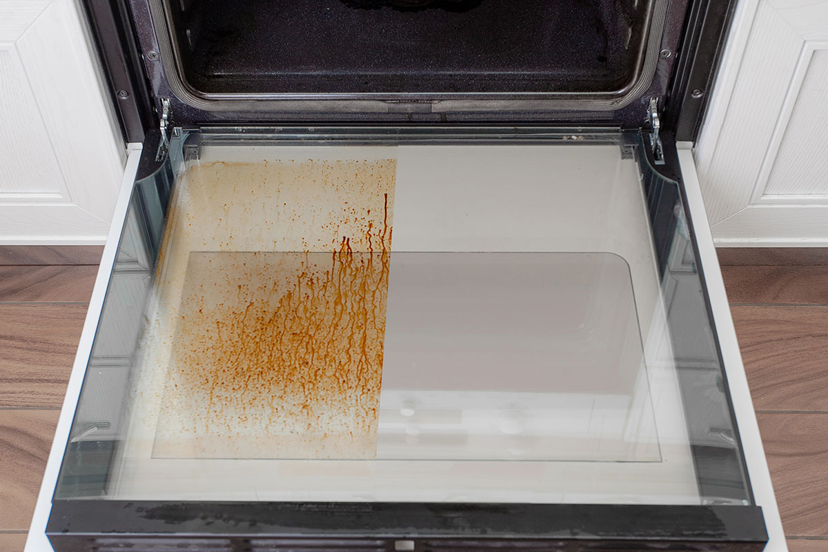 Before and after of an oven being cleaned by Infinity Home Services.